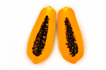 Two halves in the context, cutaway papaya, pawpaw on a white isolated background. melon tree, melon tree fruit