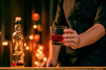 Barman pouring whiskey whiskey glass beautiful night