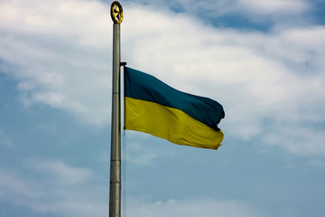 Yellow-blue Ukrainian flag is developing against the sky