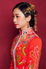 Beautiful young Asian ancient bride in red background