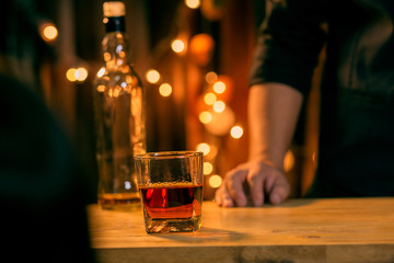 Barman pouring whiskey whiskey glass