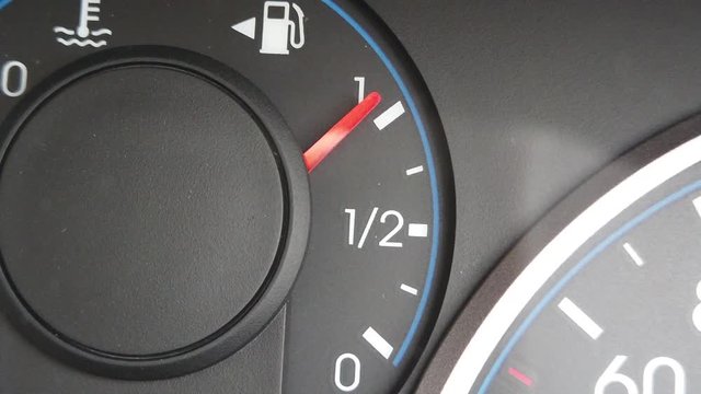 Fuel Gauge Car Dashboard Fills up. When Tank is Full or Vehicle Activated. Close Up petrol meter on black background, Gasoline Prices and Tax concept India