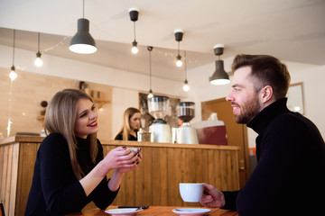 Young couple talking in a coffee shop