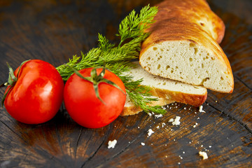 bread and tomatoes on wooden background