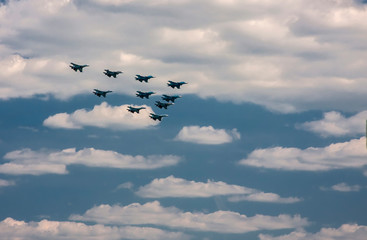 Fototapeta premium Fighting aircraft in the form of a triangle fly across the sky