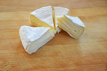 Fototapeta na wymiar Creamy Camembert soft cheese and on wooden background. Cheese Breakfast