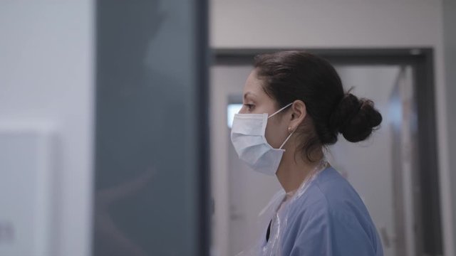 Determined nurse applying mask during the coronavirus pandemic.