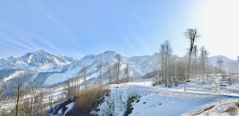 vacationers on the background of peaks in a ski resort