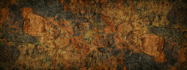 Black red grunge background. Fragment of a mountain close-up. It looks like rusty metal. Grunge banner with copy space. Rusty rough stone surface.