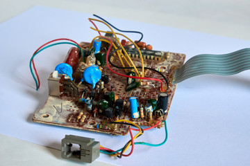 Chernihiv region, Ukraine, April 25, 2019. Old printed circuit board with many wires and elements.