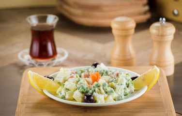 bowl of traditional russian salad on wooden table