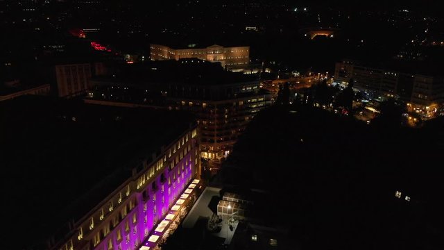 Syntagma square by night aerial drone shot behind of buildings