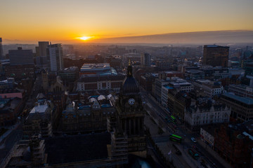 Fototapeta na wymiar Aerial photo of a beautiful sunrise rising over the town of Leeds in West Yorkshire UK.