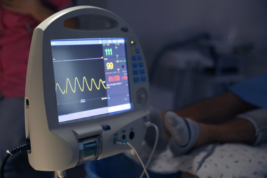 Medical heart rate monitor near patient in surgery room