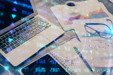 Financial graph colorful drawing and table with computer on background. Multi exposure. Concept of international markets.