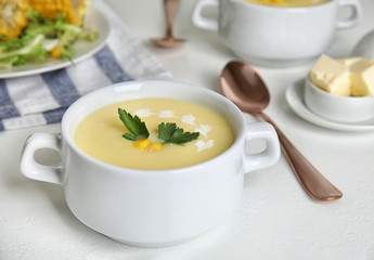 Delicious corn cream soup served on white table