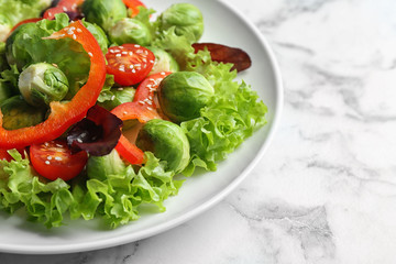 Tasty salad with Brussels sprouts on white marble table, closeup