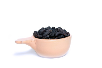 ceramic plate of raisins isolated on white background