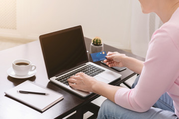 Senior woman buying goods in internet at home, close up