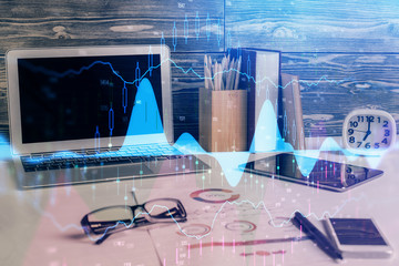 Multi exposure of graph and financial info and work space with computer background. Concept of...