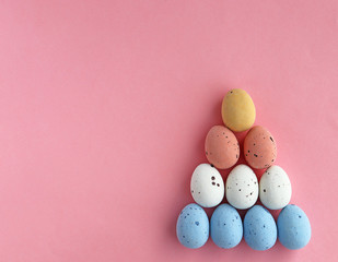 Easter colored eggs on a pink background