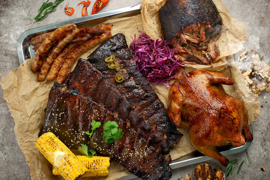 smoked pork ribs, torn pork, grilled sausages , grilled chicken with corn, sauces and Cole slaw salad