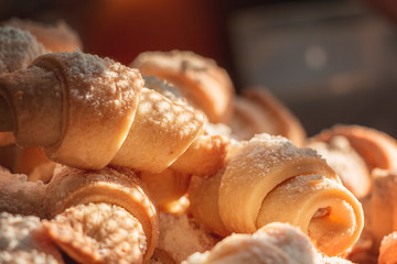 sweet homemade bagels, small in size, with jam sprinkled with icing sugar
