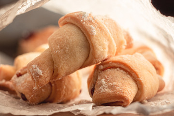 sweet homemade bagels, small in size, with jam sprinkled with icing sugar