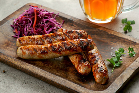 grilled sausages with Cole slaw salad and a glass of beer