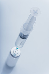 Medicine, Injection, vaccine and disposable syringe, drug concept. Sterile vial medical syringe needle. Macro close up. Glass medical ampoule vial for injection. Bottles ampule with aluminum cap.