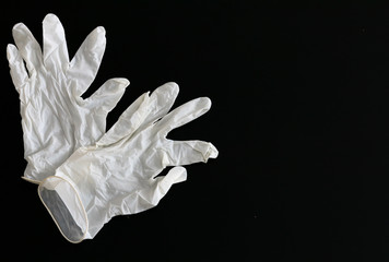 White latex gloves close-up on black background