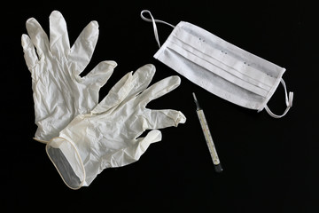 White latex medical gloves, thermometer and medical mask close-up