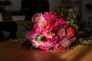 Modern white u-shaped kitchen in scandinavian style. Open shelves in the kitchen with plants and jars. Spring decoration spring flowers
