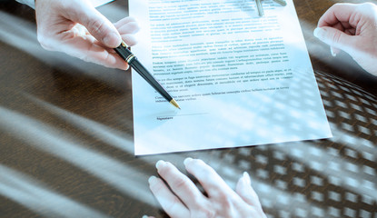 Realtor showing the signature place of a contract; light effect