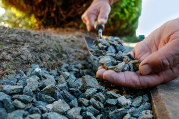 How to make a decoration from small pebbles next to a path in the garden.