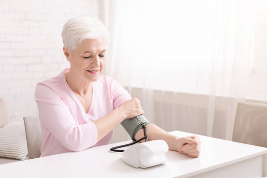 Senior Lady With Hypertension Measuring Blood Pressure Herself