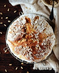 Homemade bread with sunflower seeds on a dark wooden background