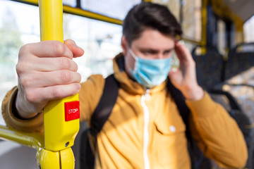 Man with surgical mask in public transport