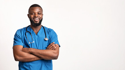 Young african surgeon posing over white background