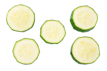 fresh green zucchini slices isolated on white background. top view