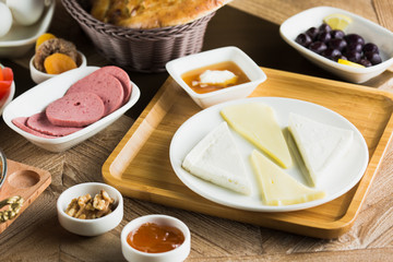 Traditional Turkish Breakfast with sesame bagel and fry egg with sausage.Used ceramic breakfast set and copper egg pan.