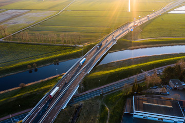 A viaduct bridge crossover a canal of highway A59 during sunrise near Waalwijk, Noord Brabant,...