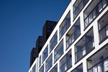 Fototapeta premium Modern european apartment building with balconies on a clear sunny day