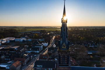 A church during sunrise on a sunny morning in the dutch town of Waalwijk, Noord Brabant, Netherlands