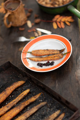 baked carrots in the autumn in the fresh air. Served on a plate.