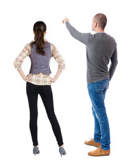 Back view of couple in sweater pointing.