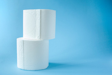 two Toilet paper roll on a blue background top view. Toilet paper purchase due to kronavirus concept. Personal hygiene and stopping the spread of the virus. Cleanliness, Hygiene, Sterility copy space