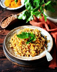 Buckwheat stew with vegetables in a ceramic bowl. rustic