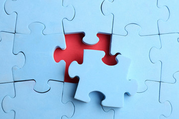 Fototapeta premium Light blue puzzle on red background, top view. Career promotion concept