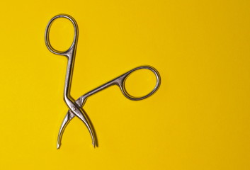 scissors for make up on a yellow background